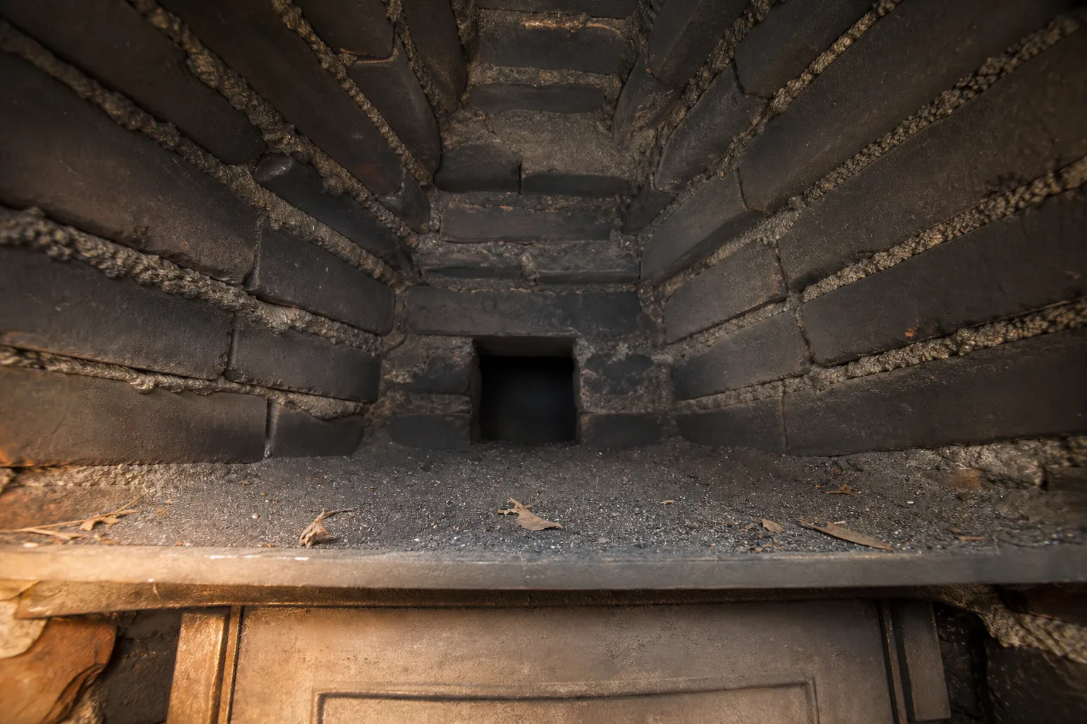 inside of a chimney at the smoke shelf and corbelled smoke chamber, sooted and stepped