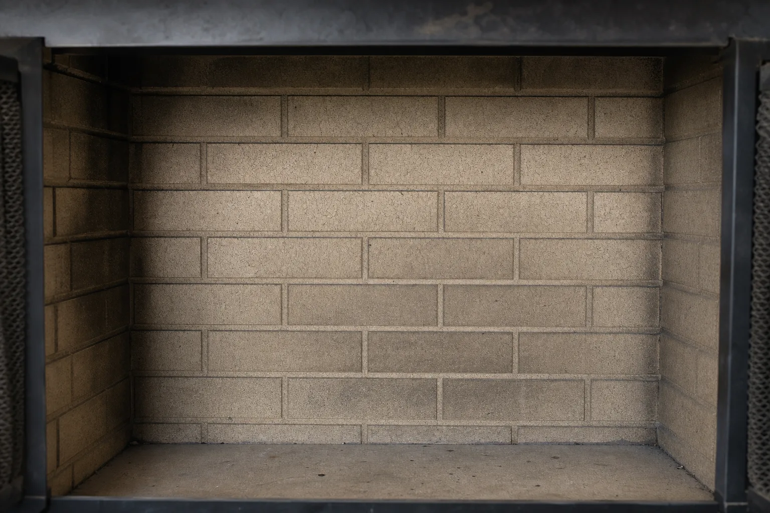 Fireplace refractory panels in sound condition with a crisp cast brick pattern and light soot