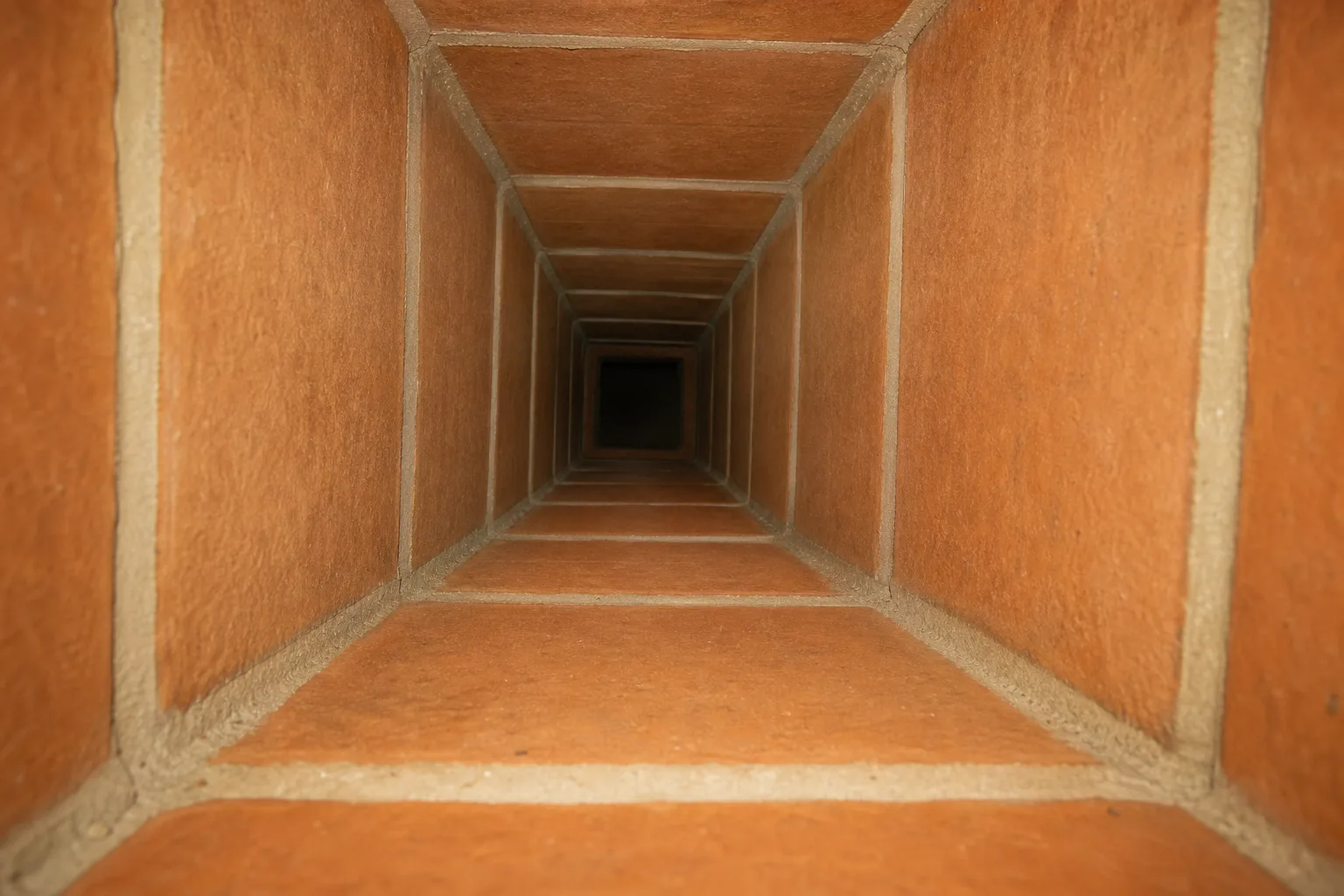 chimney flue liner in typical sound condition, with even clay tile faces and tight mortar joints