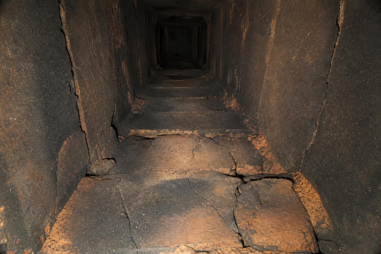 chimney flue liner in typical deteriorated condition, with cracked clay tile and open mortar joints