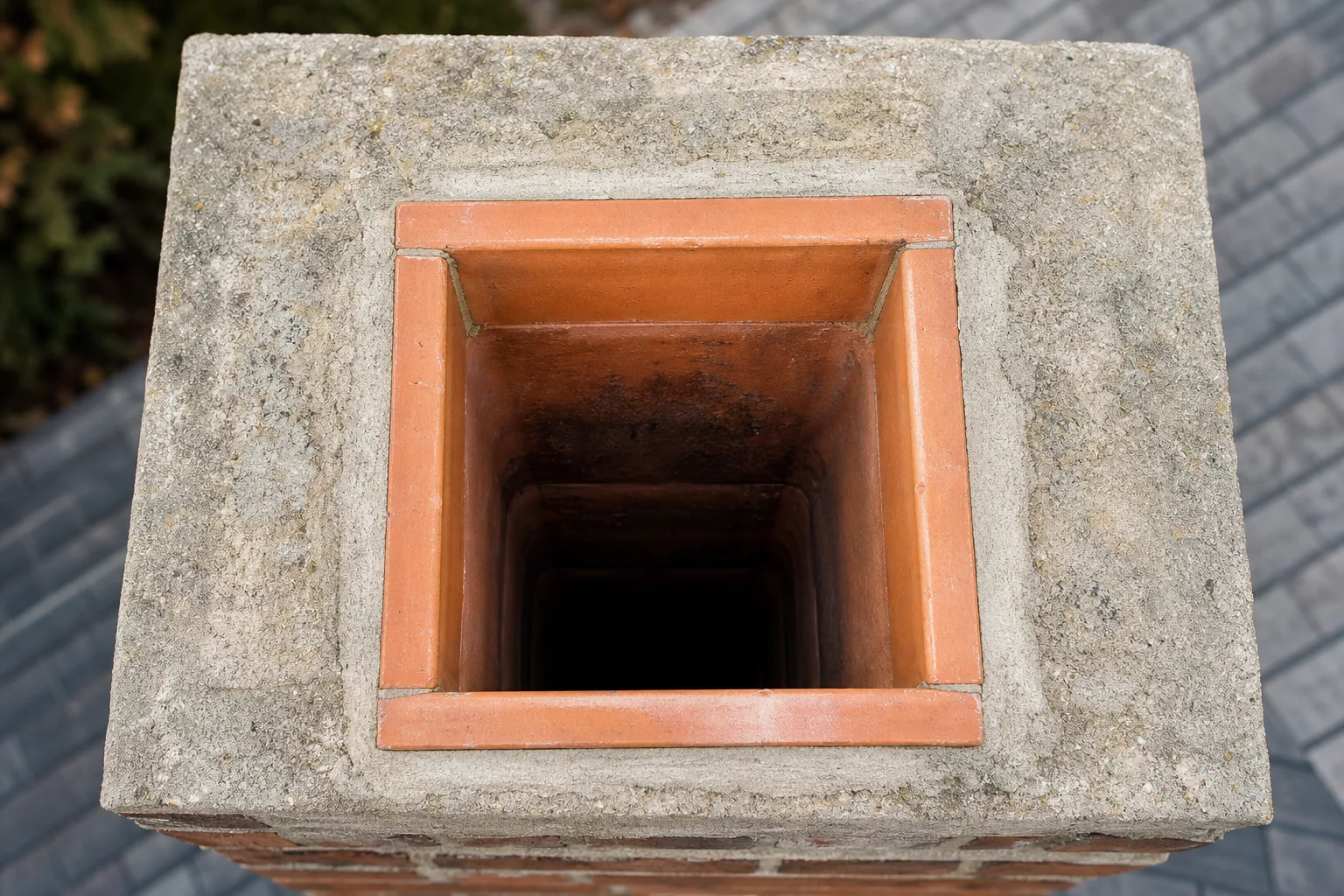 What is a chimney liner in sound condition: an intact terracotta clay flue tile seen from above the crown