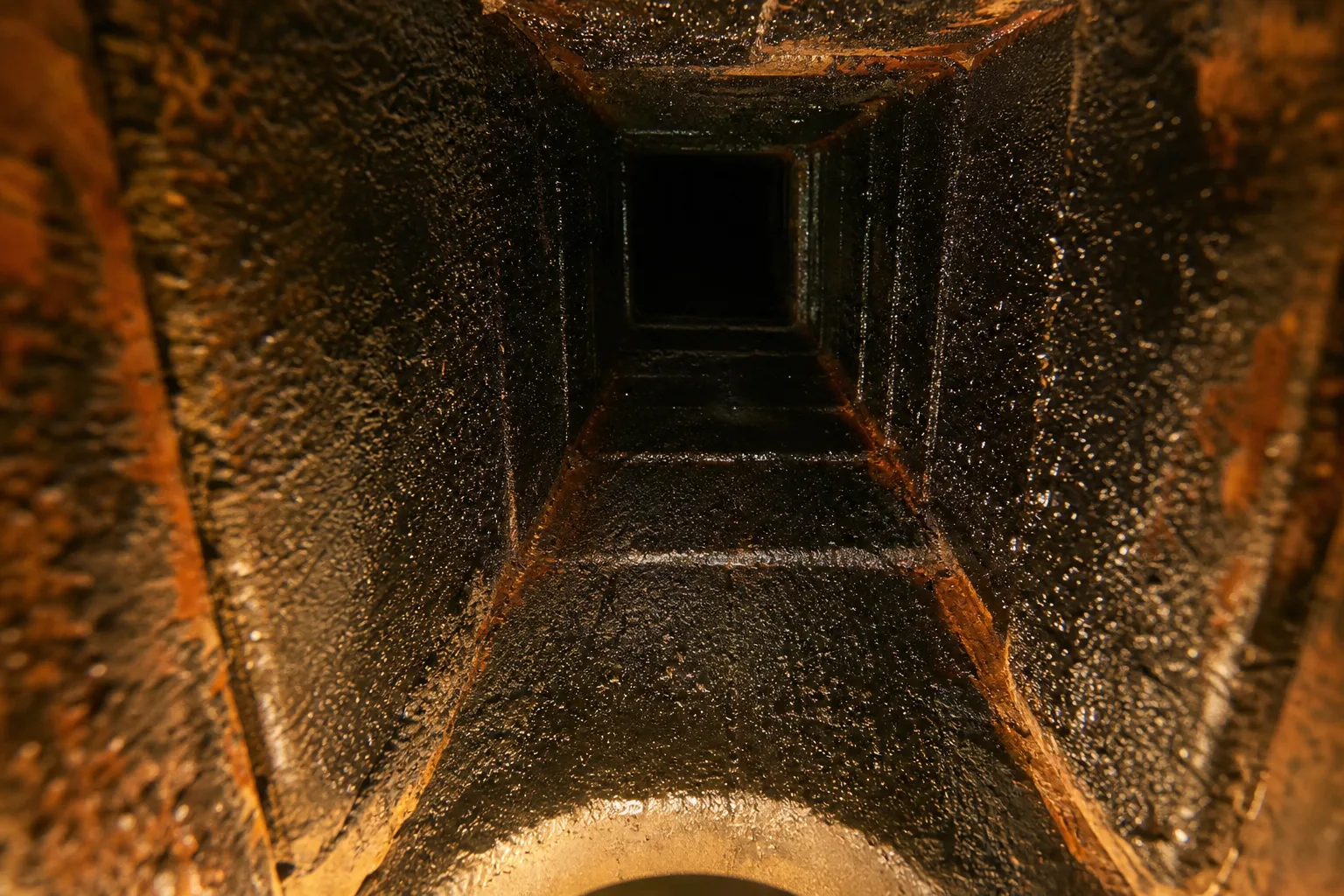 Chimney sweep Roswell finding: glazed creosote coating the clay flue tile inside a chimney