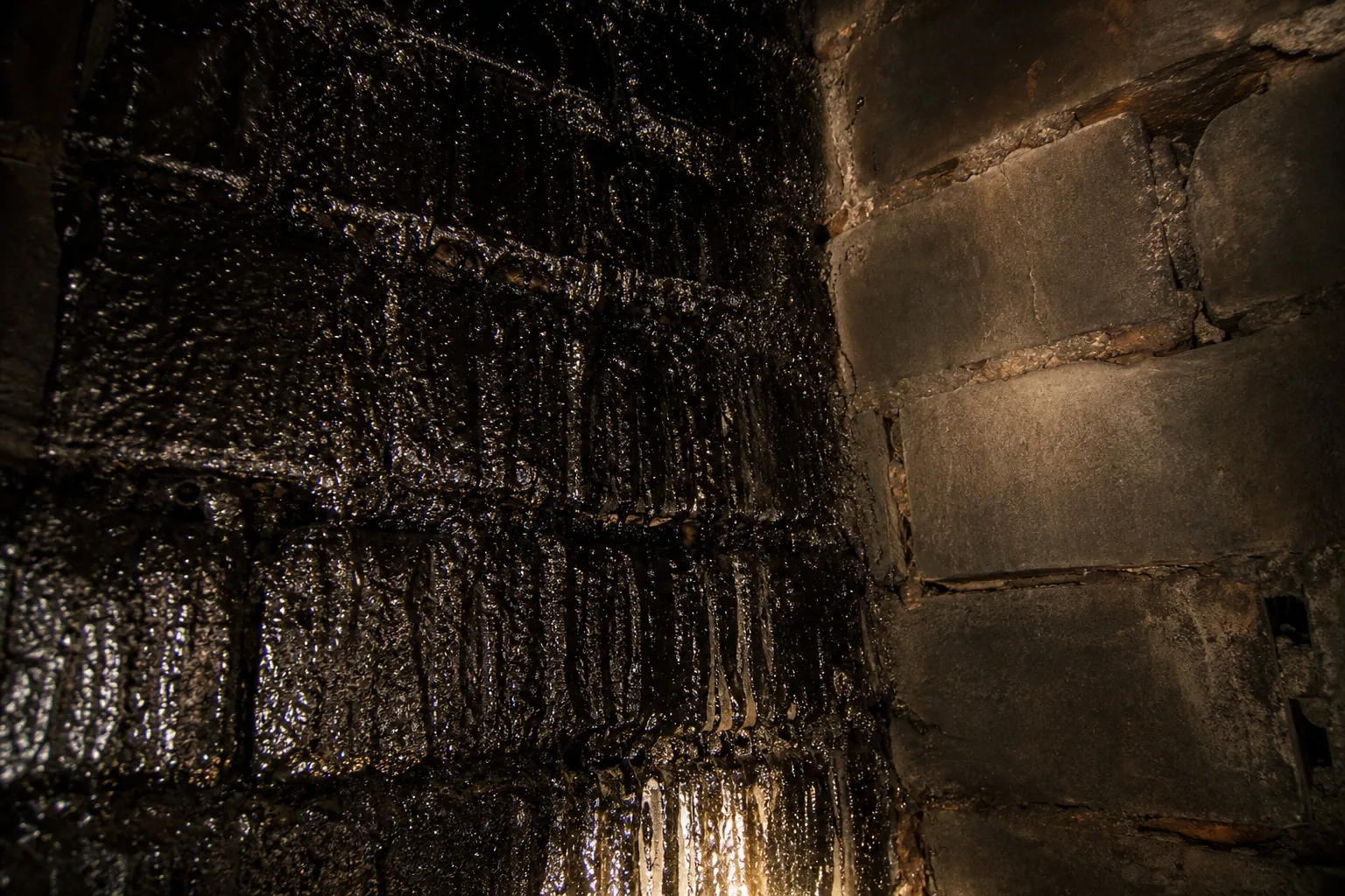 Chimney cleaning kit limits: glazed creosote on a flue wall that a brush cannot remove