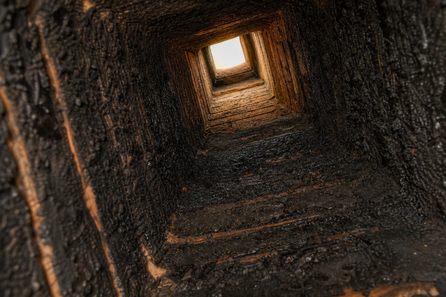 chimney brush work begins with a flue in typical sooted condition before sweeping