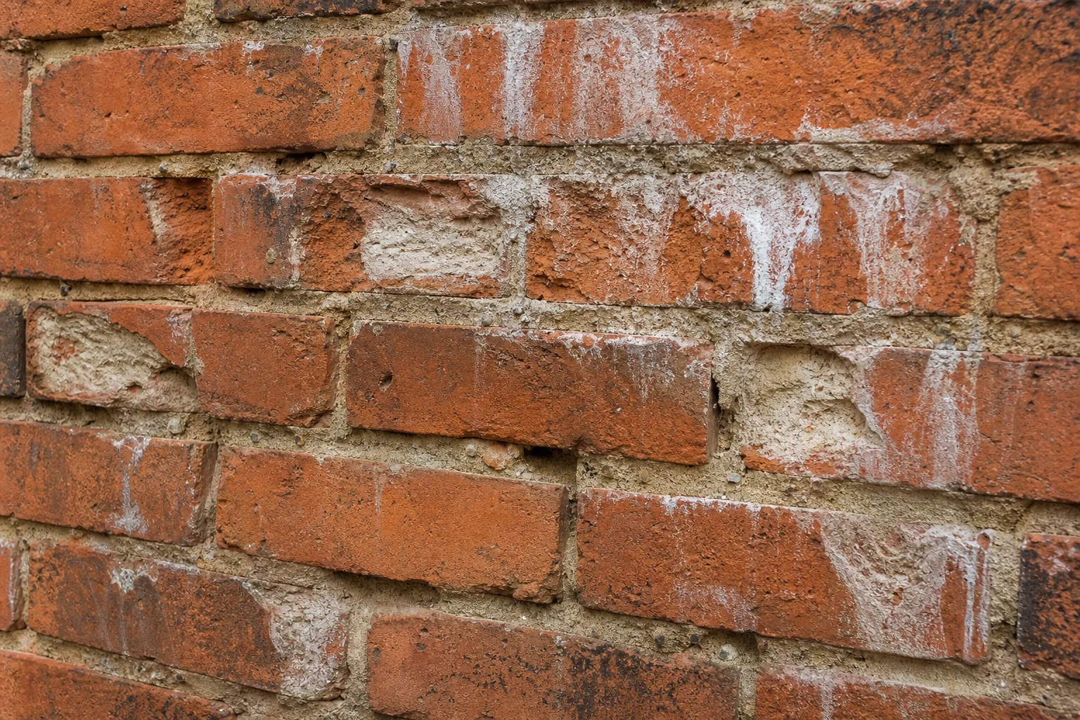 fireplace mason repair needed on spalling brick with crumbling mortar joints and white efflorescence