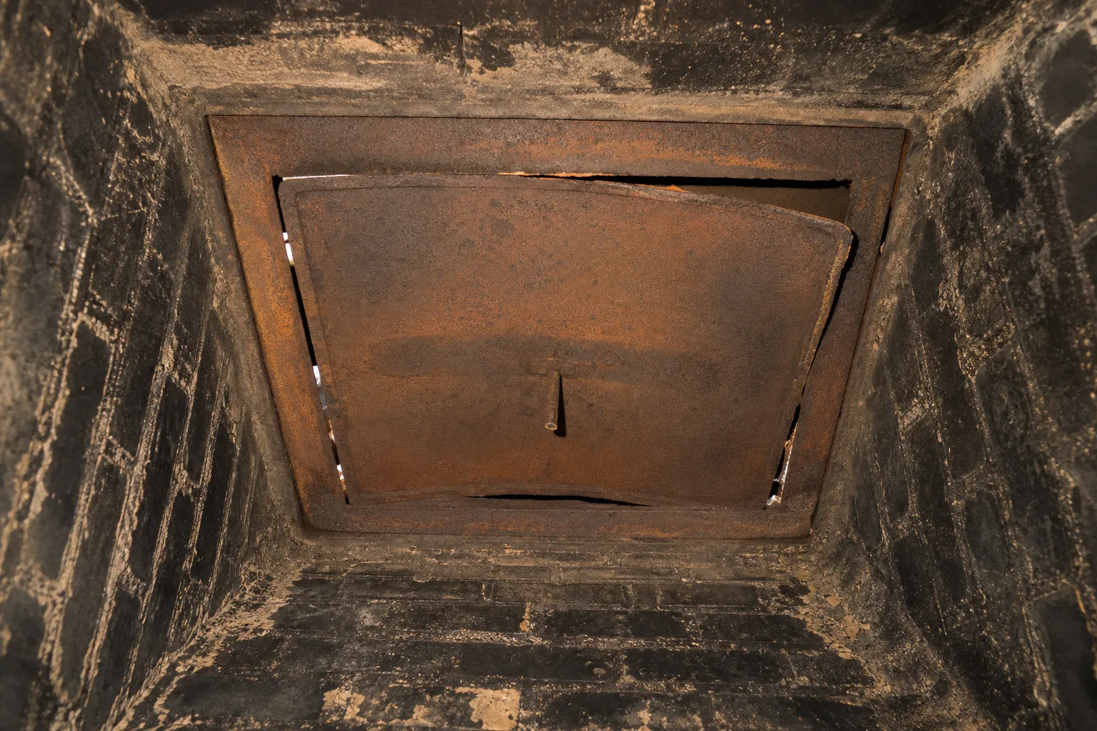 chimney balloon alternative: a worn throat damper plate that no longer seats flat, a typical worn condition